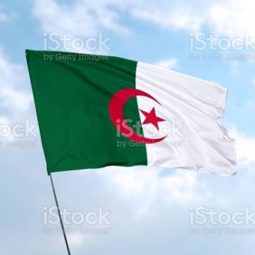 Flag of Algeria in front of the blue sky